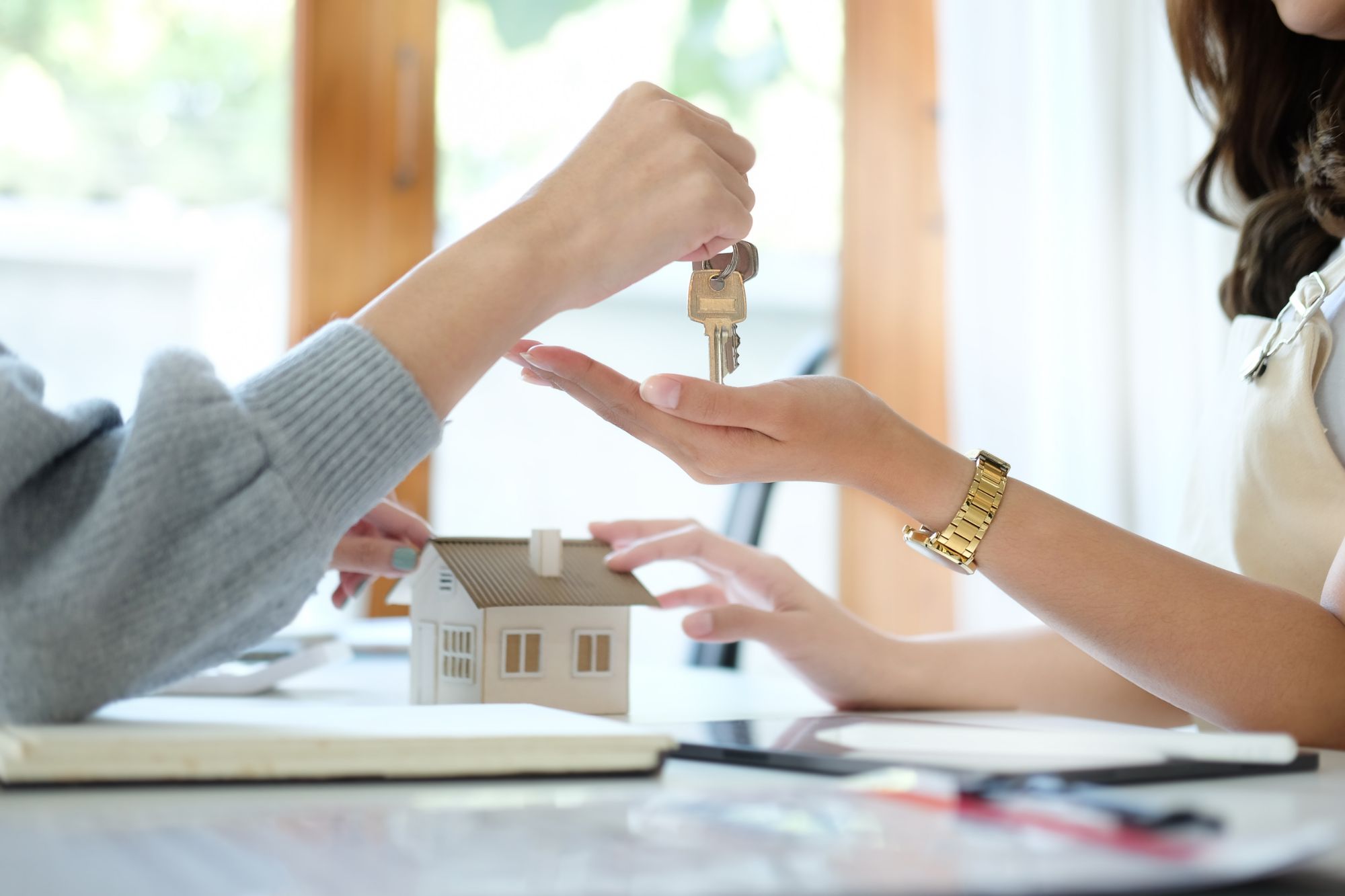 Close up view real estate agent giving keys to customer